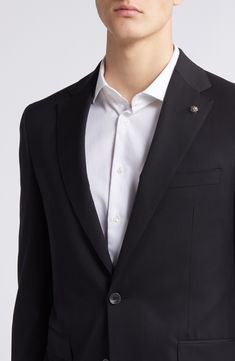 Crisp and classic, this suit tailored from black wool features traditional detailing and makes a versatile, polished addition to any formal wardrobe. Jacket has notched lapels; four-button cuffs; chest pocket; flap pockets; side vents Trousers have zip fly with button-tab closure; slant pockets; back button-welt pockets Jacket is lined; trousers are lined to the knee Unhemmed 100% wool Dry clean Made in Canada Timeless Double Breasted Long Sleeve Suit For Formal Occasions, Timeless Double Breasted Formal Suit, Timeless Long Sleeve Double Breasted Suit For Formal Occasions, Elegant Long Sleeve Double Breasted Suit For Business, Luxury Black Suit With Hidden Button Closure, Luxury Black Suits With Hidden Button Closure, Elegant Double Breasted Suit For Business Casual, Business Tuxedo With Welt Pockets, Business Double Breasted Suit With Concealed Placket