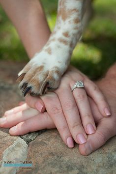 two people holding each other's hands with their wedding rings on top of them