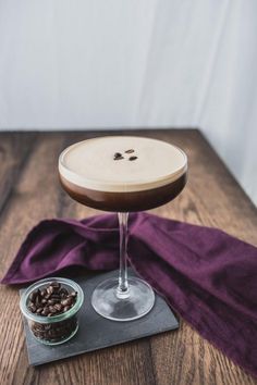 a chocolate martini with coffee beans on the side