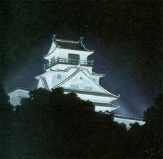 a tall white building sitting on top of a lush green forest under a dark sky