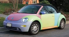 a multicolored car is parked on the street