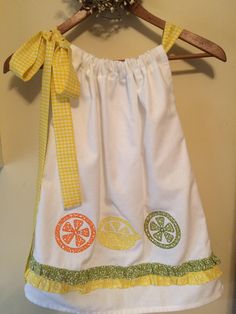 Lemonade  Party Dress with appliquéd  lemons, limes, and oranges !!!!!  A One of a Kind dress with a yellow gingham bow! by SoSewSweetCreations on Etsy https://www.etsy.com/listing/542143019/lemonade-party-dress-with-appliqued Playful White Dress For Picnic, Cotton Lemon Print Dress For Garden Party, Yellow Cotton Dress For Picnic, Green Lemon Print Dress For Garden Party, Cute Yellow Dress For Picnic, Summer Lemonade, Lemonade Party, Yellow Gingham, Yellow Bow