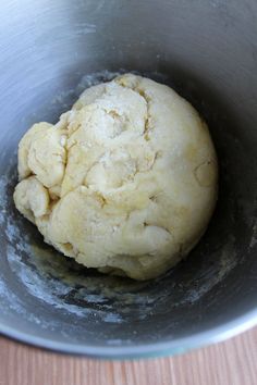 a ball of dough in a metal bowl