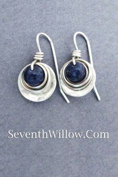 blue sapphire and sterling silver earrings Elegant Hand Forged Blue Earrings, Hand Forged Blue Round Earrings, Modern Sapphire Sterling Silver Earrings, Blue Sterling Silver Wire Wrapped Jewelry, Modern Wire Wrapped Sterling Silver Earrings, Elegant Hand Forged Sapphire Jewelry, Silver Sapphire Dangle Jewelry, Modern Wire Wrapped Round Jewelry, Nickel-free Round Silver Plated Wire Jewelry