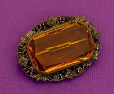 A very striking brooch with an orange gemstone and intricate adornments. GENERAL DESCRIPTION    Vintage Brooch Color: Orange and bronze tone Last photo includes measurements of the brooch.   If you have any questions please feel free to message me! Luxury Elegant Orange Brooches, Men's Brooch, Vintage Brooch, Antique Art Deco, Antique Art, Vintage Brooches, Color Orange, Brooch Pin, Brooches