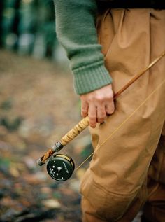 a person holding a fishing rod and a reel