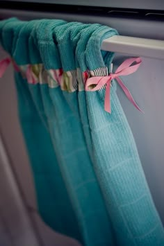 a curtain with pink and blue ribbons hanging from it