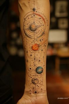 a person with a tattoo on their arm that has planets and stars all over it