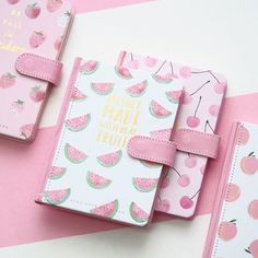 three pink notebooks with watermelon designs and the words happy march written on them