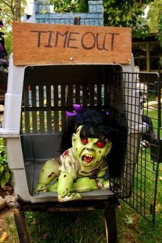 a creepy doll in a cage with the words time out on it's back