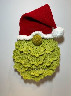 a crocheted christmas ornament with a santa hat on it's head