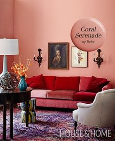 a living room with pink walls and furniture