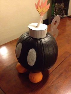 a pumpkin shaped vase sitting on top of a wooden table