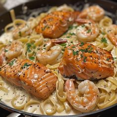 some shrimp and pasta in a skillet