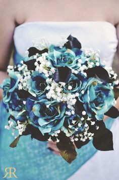 a bridal bouquet with blue roses and baby's breath