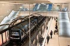 people are standing on the escalator in an underground train station