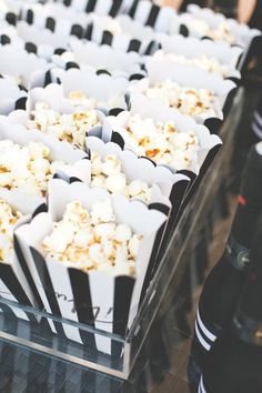 some black and white striped paper cups filled with popcorn