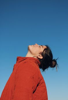 a woman looking up into the sky with her eyes closed