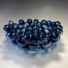 a blue bowl filled with balls on top of a table