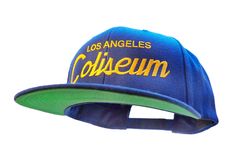 Los Angeles 90s Hat | The Coliseum Vintage-Style Embroidered Blue Snapback Cap with Yellow Script Lettering | 90's Football SnapBack Football has deep roots in Los Angeles. This six-panel snapback football hat sports a vintage 90s look. It is made of a wool/acrylic blend with a green under brim and a mid to high crown. It features classic 90's-inspired sports script embroidery, with an adjustable snap closure on the back. Ready to ship in 2-7 business days. Please be aware, we do not offer any c Vintage Snapback Baseball Cap With Letter Patch, Retro Blue Baseball Cap For Streetwear, Blue Retro Baseball Cap For Streetwear, Retro Blue Hats With Embroidered Logo, Retro Blue Hat With Embroidered Logo, Blue Retro Hat With Embroidered Logo, Retro Blue Snapback Hat For Sports Events, 90s Style Snapback Baseball Cap For Sports, Vintage Snapback Fitted Hat For Sports Events