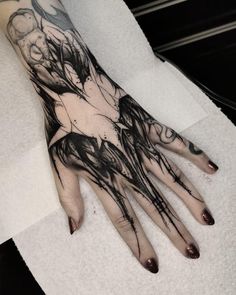 a woman's hand with black ink on it