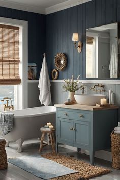 a bathroom with blue walls and white fixtures