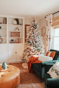 a living room filled with furniture and a christmas tree