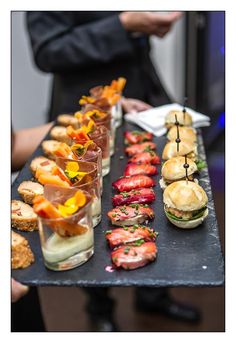 an assortment of appetizers are displayed on a tray