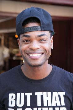 a man wearing a black hat and t - shirt with the words but that backflip on it