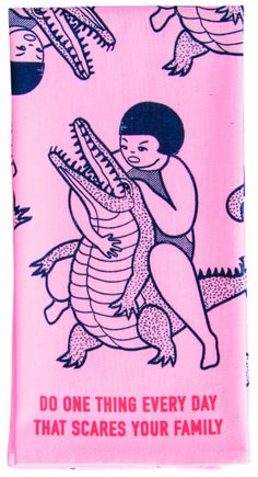 a pink towel with an image of a woman holding a crocodile on it's back