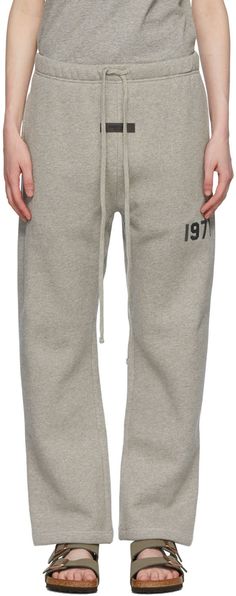 Marled cotton-blend fleece lounge pants. · Drawstring at elasticized waistband · Rubberized logo patch at front · Rib knit gusset at dropped inseam · Text flocked at leg · Two-pocket styling Please note that this item may not be shipped within the EU. Supplier color: Dark oatmeal Essentials Outfit Fear Of God Women, Relaxed Fit Cotton Sweats With Soft-washed Finish, Ankle-length Lounge Pants With Elastic Waistband, Fear Of God Pants, Ssense Diesel Gray Lounge Pants, Essentials Clothing, Fear Of God Essentials, Trouser Pants Women, Fear Of God