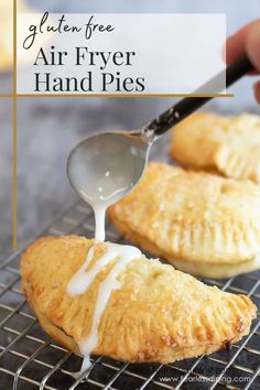 gluten free air fryer hand pies on a cooling rack with a spoon