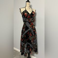 This Soft Black Floral Velvet Dress Has A Fit And Flare Style With Crossover Bodice. Dress It Up For A Night On The Town Or Add A Hat And Some Flats For A Boho Chic Vibe. Fully Lined With Back Zipper And Adjustable Bodice Straps. Elegant Black Floral Sundress, Black Fitted Rayon Dress, Black Floral Midi Dress For The Beach, Black Floral Midi Dress For Beach, Black Floral Print Sundress For Party, Black Floral Print Party Sundress, Black Printed Rayon Dresses, Black Midi Length Rayon Dress, Black A-line Midi Dress With Print