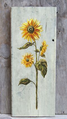 an image of a sunflower painted on a piece of wood