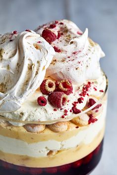 a cake with whipped cream and raspberries on top