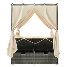 the canopy bed is made with wicker and fabric