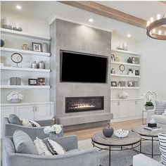 a living room filled with furniture and a flat screen tv mounted on the wall above a fireplace