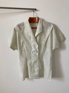 "Vintage double breasted cotton blouse for women Size 38 | Short Sleeve Blouse with delicate floral print. The greenish off white blouse has a fitted waist and a lovely sleeve pleated detail. Just a beautiful romantic summer blouse, great with jeans, shorts, skirts too. Composition: probably cotton. no composition tag attached.  Size: 38 Condition: excellent Measurements*: Armpit to armpit: 46 cm | 18.1\" Length: 68 cm | 26.8\" Waist: 42 cm | 16.5\" Hips: 50 cm | 19.7\" Shoulders: 40 cm | 15.7\" Classic Short Sleeve Tops For Wedding, Classic Floral Print Tops For Daywear, Elegant Cotton Floral Print Blouse, Elegant Cotton Blouse With Floral Print, Cotton Top For Wedding In Spring, Classic Summer Wedding Top, Formal Cream Cotton Top, Spring Wedding Button-up Blouse, Cream Cotton Top For Formal Occasions