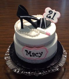 a birthday cake decorated with shoes and pearls