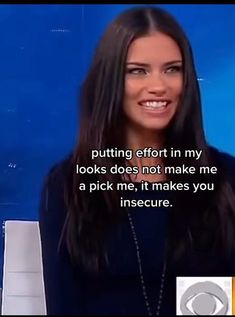 a woman with long dark hair is smiling at the camera and has an interesting message on her face