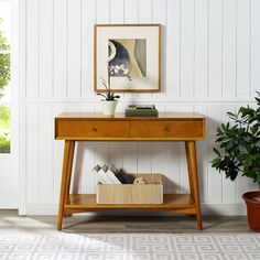 a wooden table sitting next to a potted plant