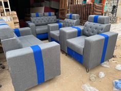 several gray and blue couches sitting on the ground