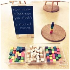 there are two bins filled with cubes next to a sign that says how many cubes can you stick?