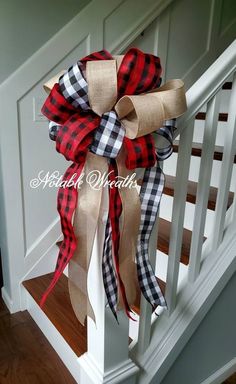 a red and black plaid bow on the banister