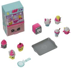 an assortment of toys including a toy ice cream machine and other items on a white background