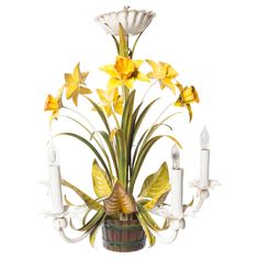 a candle holder with flowers and candles in it