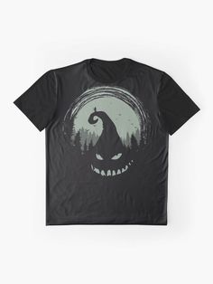 a black t - shirt with an image of a scary face and trees in the background