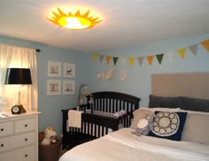 a baby's room with blue walls and white furniture