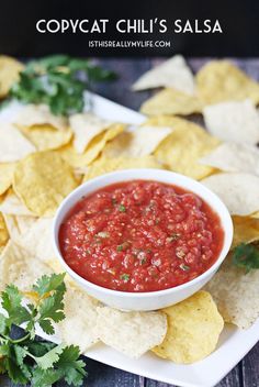 a white plate topped with chips and salsa