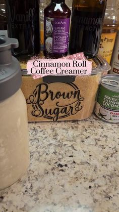 the coffee creamer is sitting on the counter next to some other drinks and condiments